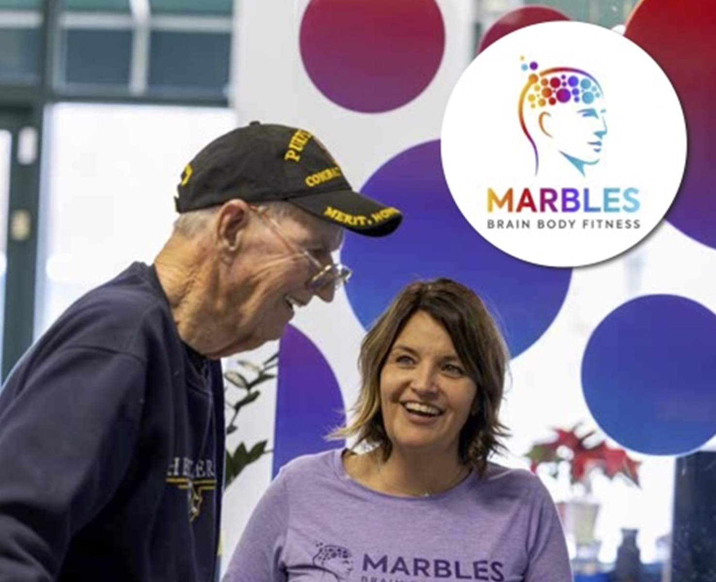 Sharea Clark laughing with a Marbles member at the Fishers studio