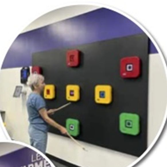 A member training on the light-up reaction wall at the Fishers studio
